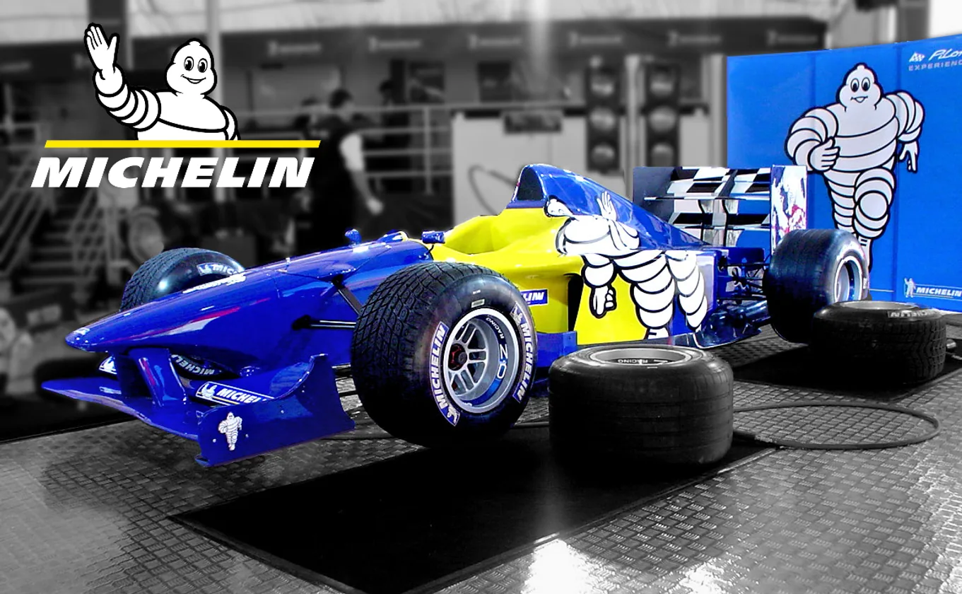 A Michelin show car and tyre display in a monochrome showroom
