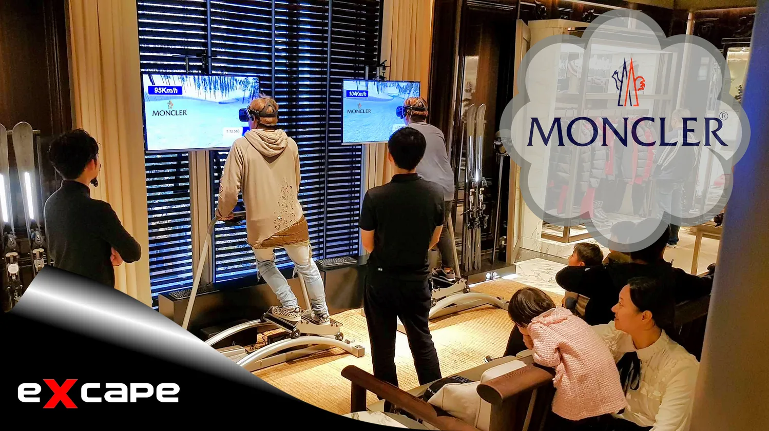 Guests on a snow ramp in front of Excape screens at a Moncler activation
