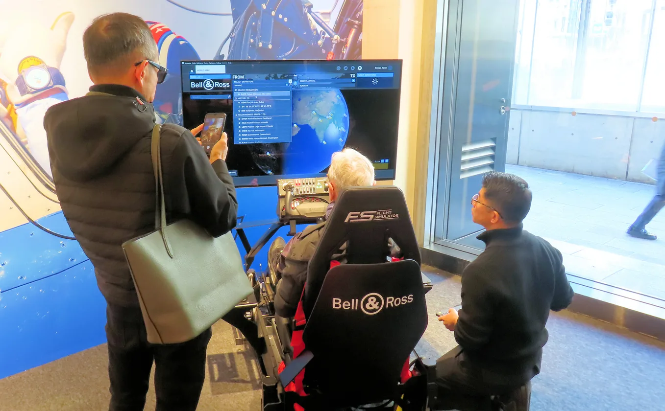 Visitors at a Bell & Ross simulator activation seen through a store window