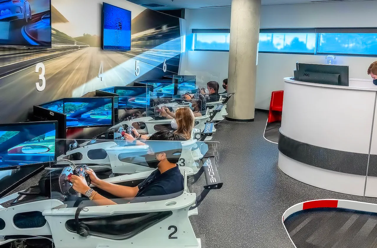 A numbered row of racing stations in use, with a reception desk beyond