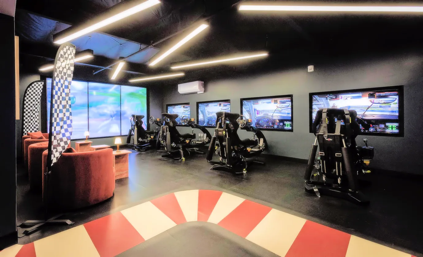 An esports racing venue with a red and white floor and its own lounge