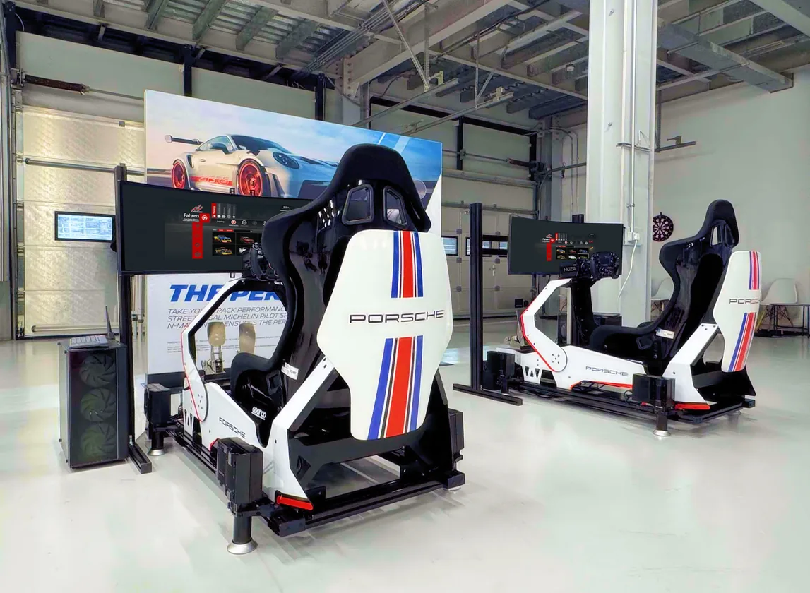 Porsche Martini-liveried rigs in a workshop-style esports space